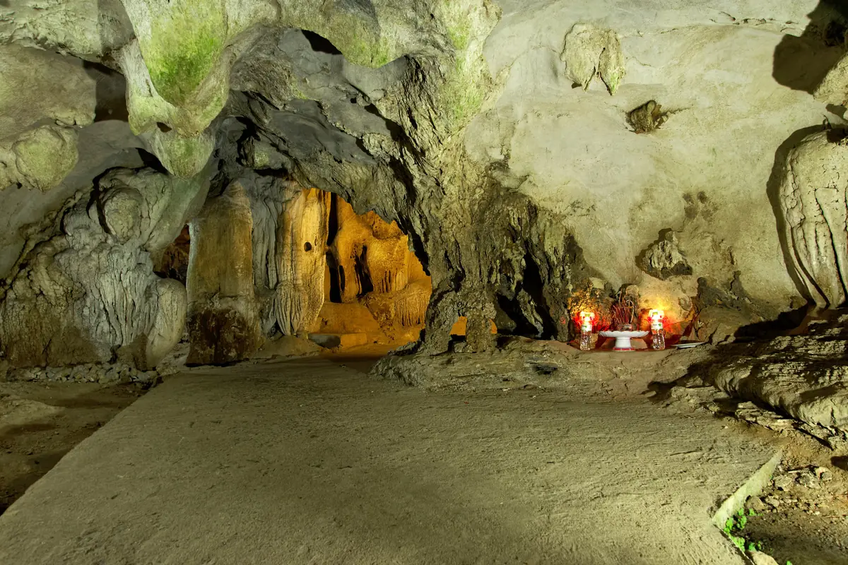 Inside Trung Trang Cave, with a lit path under the limestone vault, Cat Ba Island, January 2024